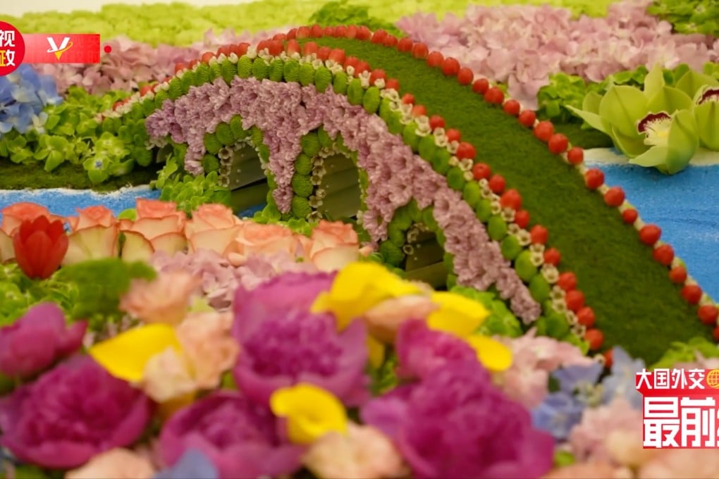 At Henry Kissinger’s lunch with Chinese President Xi Jinping, the table decorations included a sprawling miniature landscape featuring a bridge that state broadcaster CCTV said represented the “bridge between China and the United States”, seen here in this screenshot taken from the CCTV video. Photo: CCTV