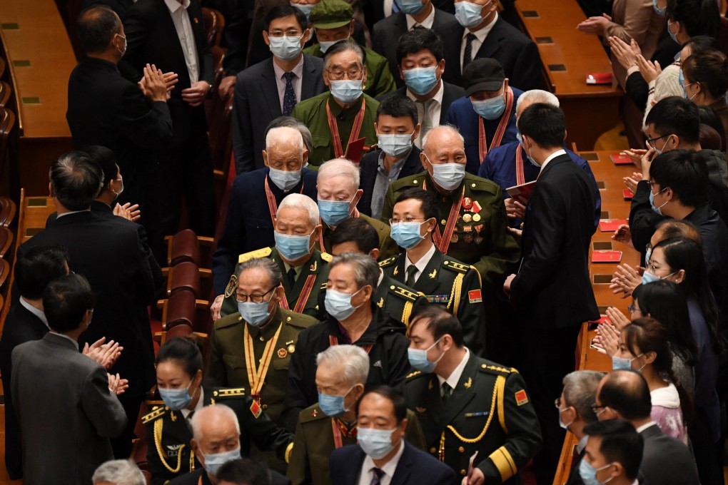 Veterans are applauded as they arrive in Beijing’s Great Hall of the People in October 2020. Photo: AFP