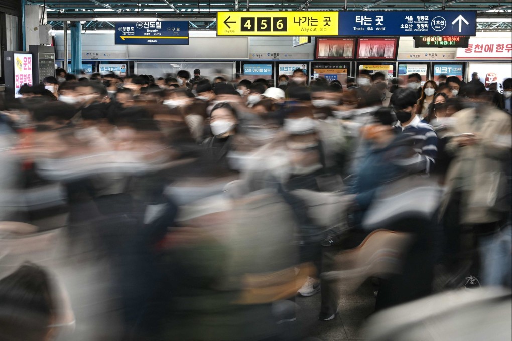 Commuters walking through a subway station in Seoul. File photo: AFP