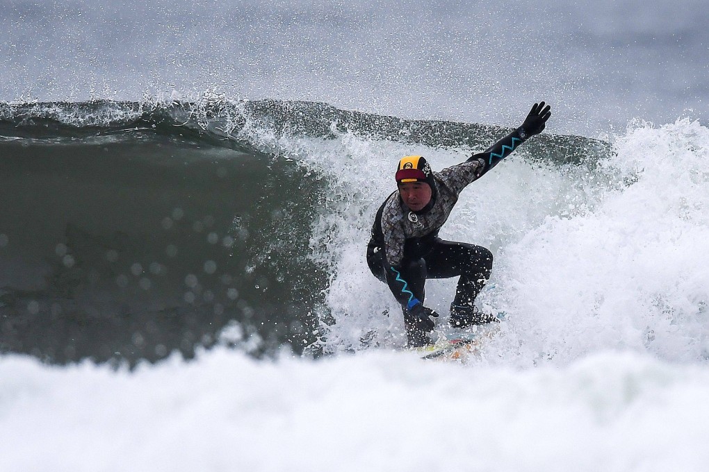 A surfer riding a wave in Minamisoma, Fukushima prefecture. Photo: AFP