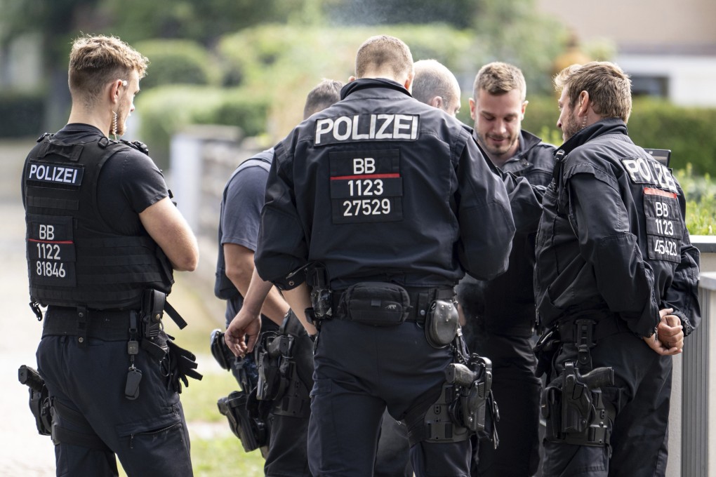 Police officers coordinate the search for a wild animal in a residential area in Teltow, Germany on Thursday. Photo: dpa via AP