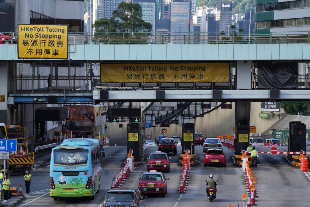 Vehicles pass closed toll booths at the Cross-Harbour Tunnel, with a new auto-pay system in force. Photo: Elson Li
