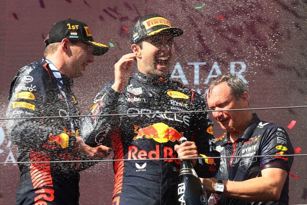 Red Bull’s Max Verstappen celebrates on the podium with the trophy after winning the Hungarian Grand Prix alongside teammate Sergio Perez. Photo: Reuters