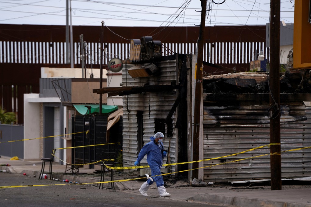 A forensic technician outside a bar in San Luis Rio Colorado, Mexico, where a man threw a Molotov cocktail bomb on Saturday after being kicked out for bad behaviour. Photo: Reuters