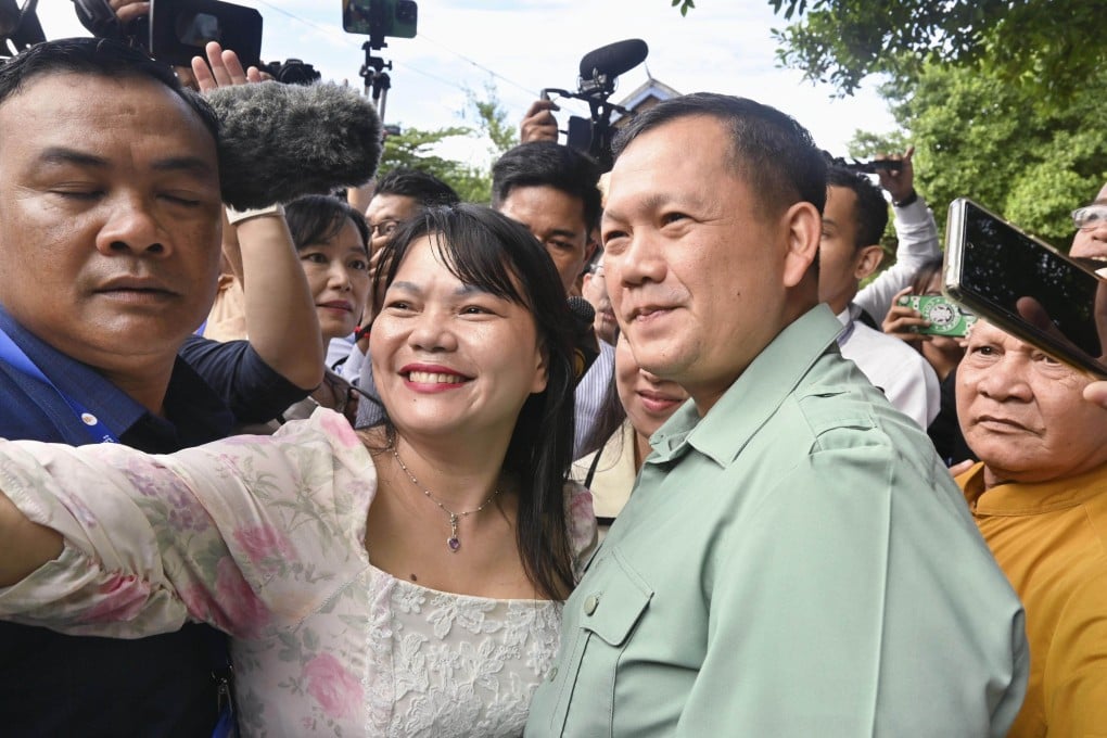 Hun Manet, the eldest son of Cambodian Prime Minister Hun Sen, poses for a photo with a supporter in Phnom Penh on Sunday. Will he soon be the nation’s leader? Photo: Kyodo