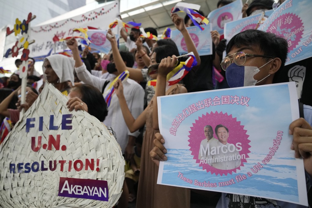 A protester holds a sign with a photo of Philippine President Ferdinand Marcos Jnr during a rally outside the Chinese consulate in Makati, Philippines, on July 12. The gathering marked the seventh anniversary of the issuance of the 2016 decision by an arbitration tribunal set up under the UN Convention on the Law of the Sea after the Philippines complained against China’s increasingly aggressive actions in the disputed South China Sea. Photo: AP
