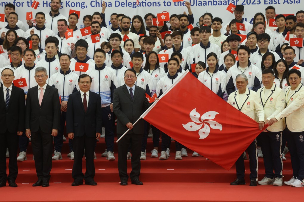 Hong Kong’s Acting Chief Executive Chan Kwok-ki (holding flag) joins members of the city’s squad for the forthcoming Asian Games. Photo: Yik Yeung-man