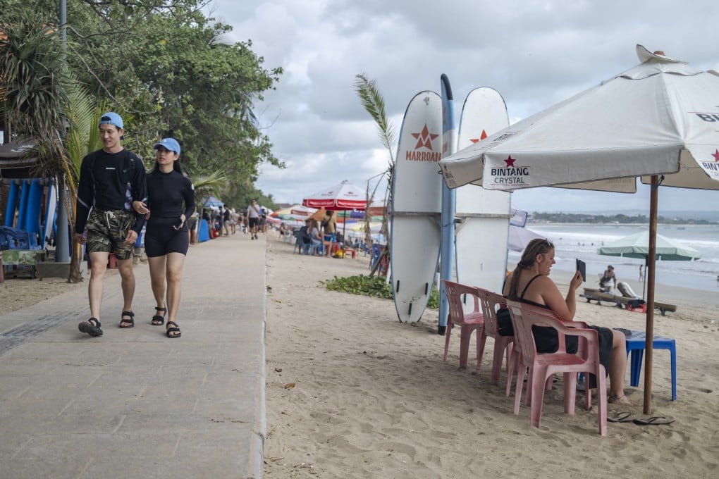 Foreign tourists walk at a beach in Kuta, Bali. The island attracted some two million visitors in 2022. Photo: EPA-EFE
