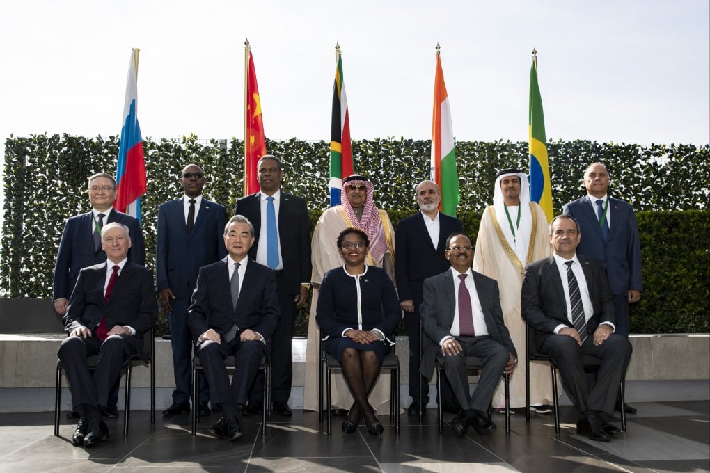 Wang Yi (seated, second left) with delegates from Brics and other countries in Johannesburg, South Africa, on Monday. Photo: Xinhua