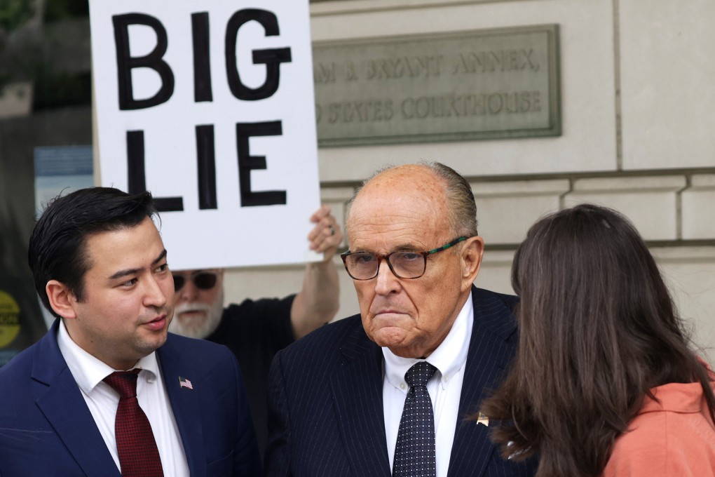 Rudy Guiliani, right, the former personal lawyer for ex-president Donald Trump, talks to the press outside court in May. Photo: Getty Images