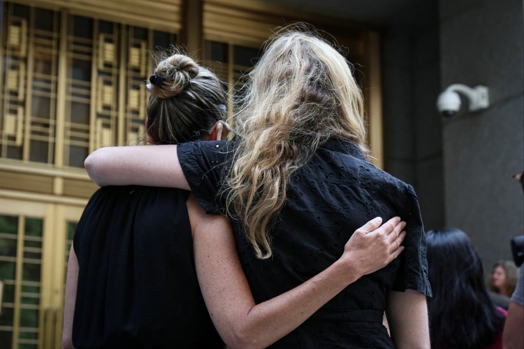 Sexual assault survivors embrace following the sentencing of former gynecologist Robert Hadden, outside the Manhattan federal court in New York City. Photo: Reuters