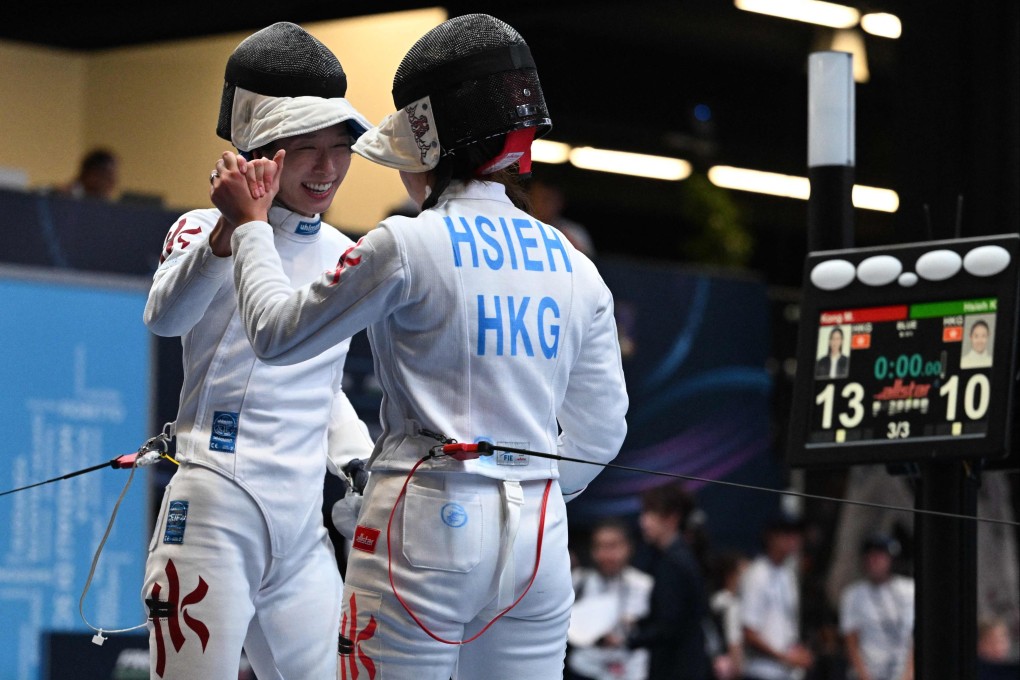 Vivian Kong shares a moment with fellow Hongkonger Kaylin Hsieh after defeating her in Milan. Photo: AFP