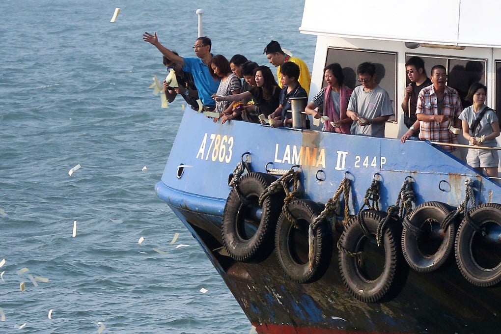 Family members perform rituals off Lamma Island following the horrific ferry disaster in October 2012. Relatives of the dead now will get the inquest they wanted. Photo: David Wong