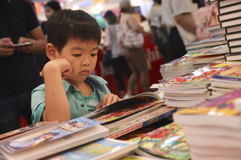 A young reader peruses a book during Hong Kong Book Fair 2023. Drawing nearly 1 million attendees, the event continued the city’s return to pre-pandemic life. Photo: Yik Yeung-man