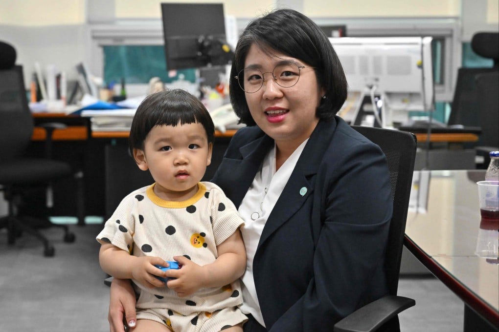 Yong Hye-in with her two-year-old son Bak Dan in her office at the National Assembly in Seoul. Photo: AFP