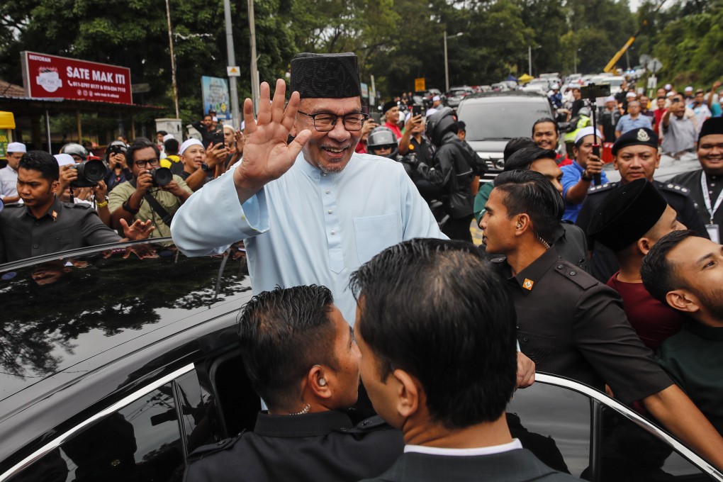 Malaysian Prime Minister Anwar Ibrahim waves as he leaves after Friday prayers at a mosque in Gombak, outside Kuala Lumpur, on July 14. Photo: EPA-EFE