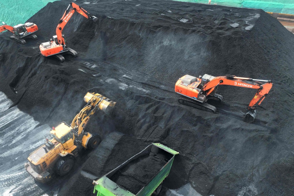 Coal is loaded onto trucks for delivery to power generation plants after being unloaded from ships at the port in Lianyungang, in Jiangsu province, on July 12. China’s increasing use of coal is at odds with its public commitment to reduce carbon emissions. Photo: AFP