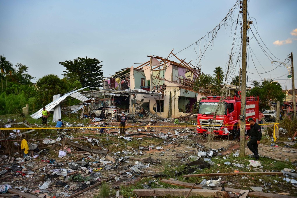 Thai police, rescuers and locals gather around destroyed homes after an explosion ripped through a fireworks warehouse, killing 9 people and injuring more than 100, in Sungai Kolok district in the southern Thai province of Narathiwat on Saturday. Photo: AFP