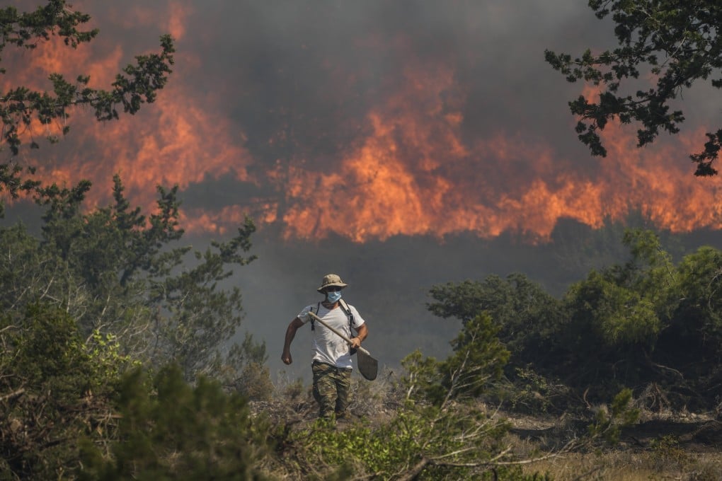 Flames burn a forest in Vati village, on the Aegean Sea island of Rhodes, southeastern Greece, on Tuesday. Photo: AP