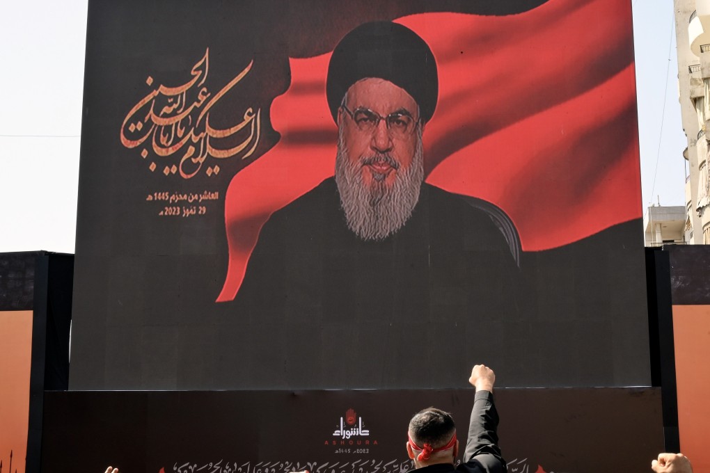 Hezbollah leader Hassan Nasrallah appears on a screen as he speaks to supporters during Ashura Day in southern Beirut, Lebanon. Photo: EPA-EFE