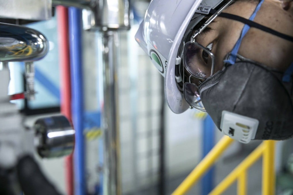 A worker checks machinery at a battery parts maker in South Korea. Analysts say partnerships with Chinese firms can be risky for Korean companies because the US could still block joint ventures from any IRA tax benefits. Photo: Bloomberg