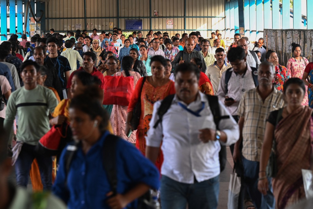 Commuters walk over a bridge in Mumbai earlier this year. India surpassed China as the world’s most populous country in 2023, and investors say its booming tech scene, buoyant stock market and youthful population mean it’s set for rapid growth. Photo: AFP