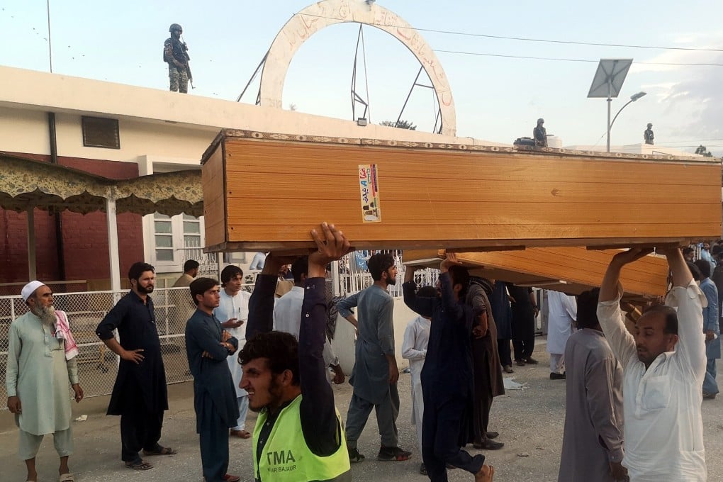 People carry coffins to collect the bodies of victims outside a hospital following an explosion in Bajaur, Pakistan on Sunday. Photo: EPA-EFE