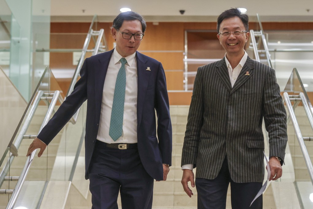 Governing council vice-chairman Norman Chan (left) and chairman Professor John Chai leave Thursday’s meeting. Photo: Jonathan Wong