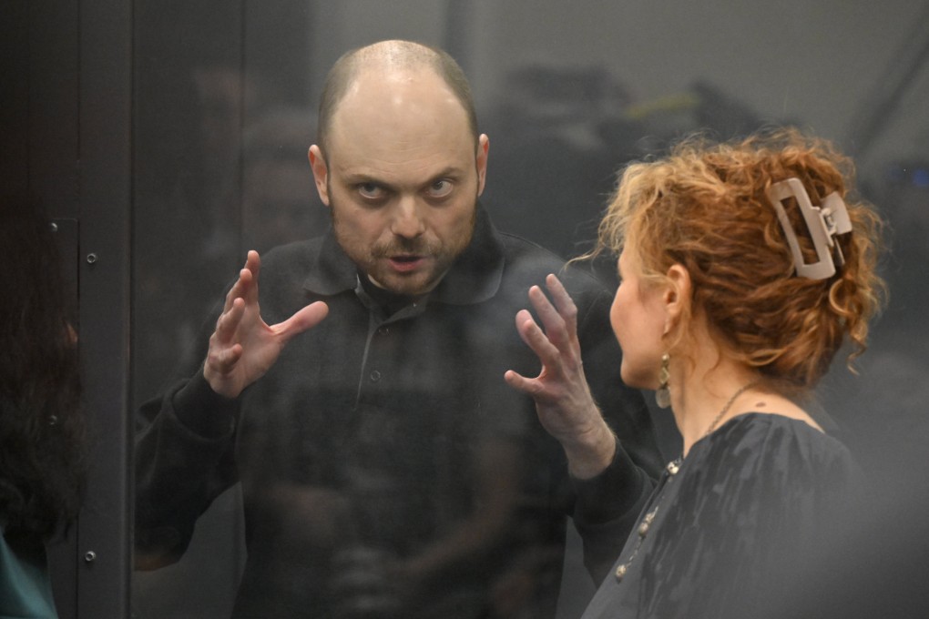Russian opposition activist Vladimir Kara-Murza speaks to his lawyer standing in a glass cage at Moscow City Court in Moscow, Russia on Monday. Photo: AP