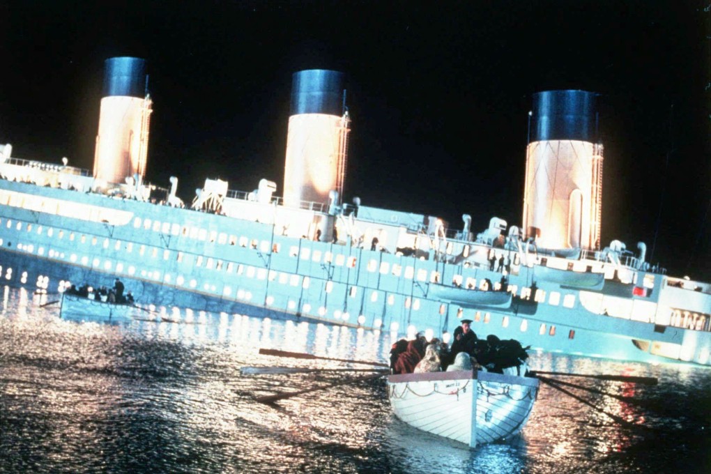 Passengers aboard lifeboats row to safety as the Titanic sinks in a scene from the 1997 James Cameron film “Titanic”. Photo: AP Photo/Paramount Pictures/20th Century Fox