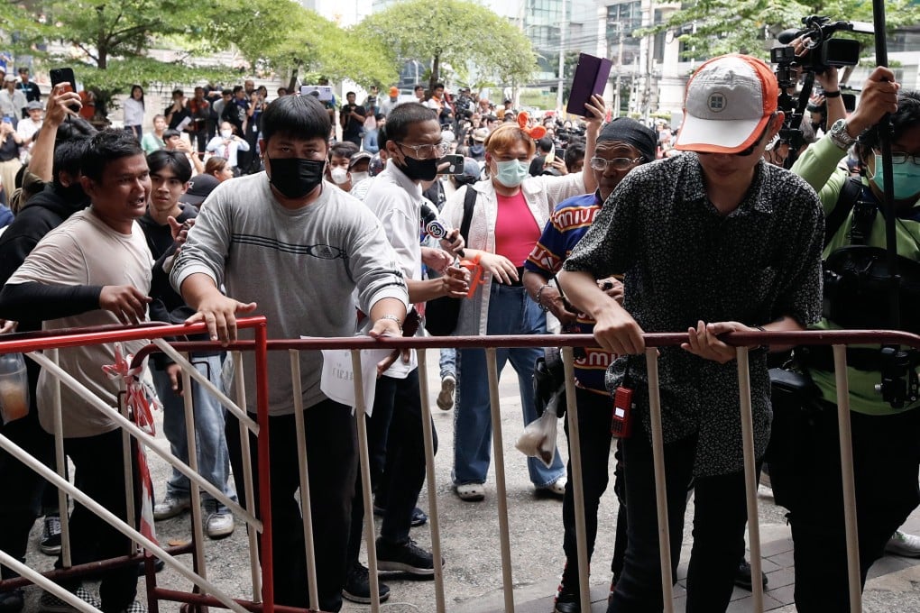 Supporters of Thailand’s election-winning Move Forward Party try to remove barricades during a protest on Wednesday over its exclusion from the coalition that is trying to form a government. Photo: EPA-EFE