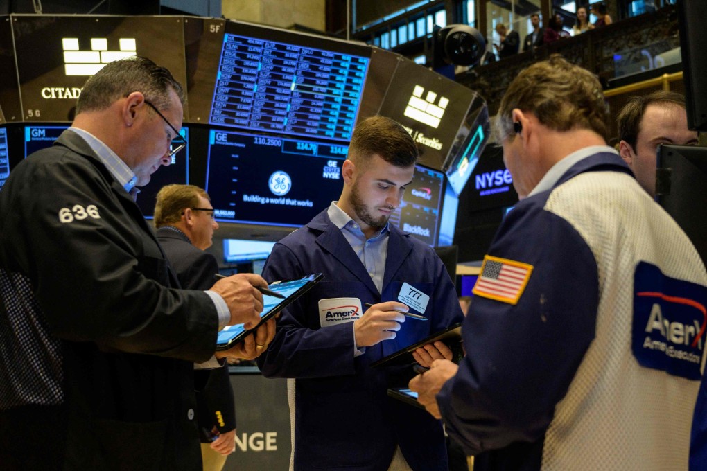 Traders work the floor of the New York Stock Exchange on Friday. Photo: AFP