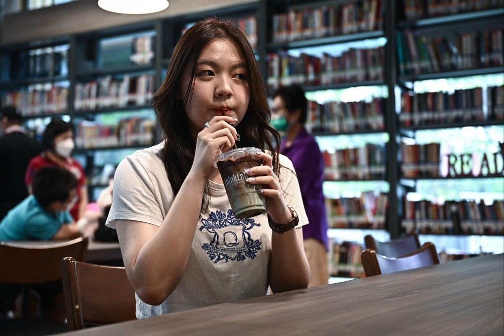 A customer drinking an iced chocolate-mint drink at the ThinkLab cafe in Pheu Thai party’s Bangkok headquarters. Photo: AFP