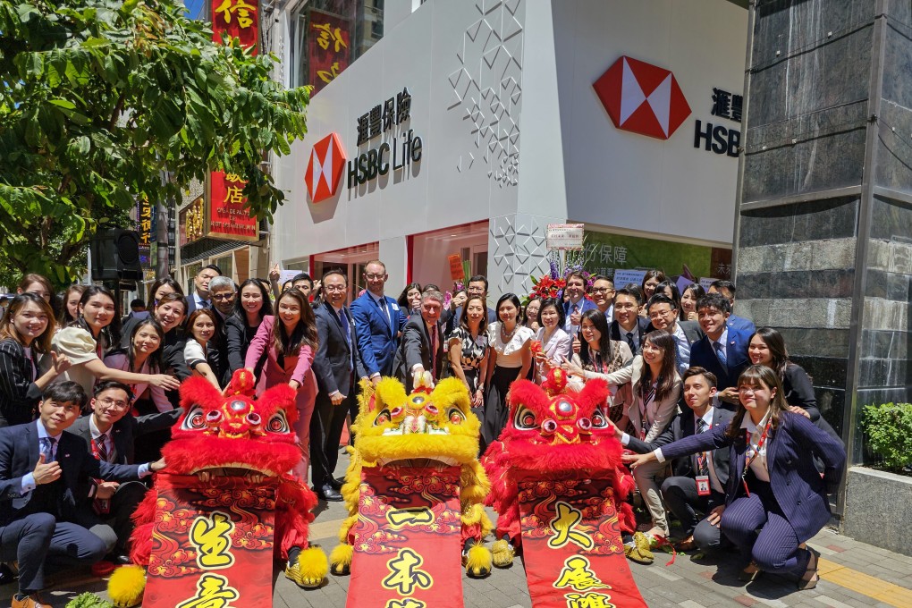 HSBC Life executives at the lion dance ceremony for its Macau centre opening on August 3, 2023. Photo: Enoch Yiu