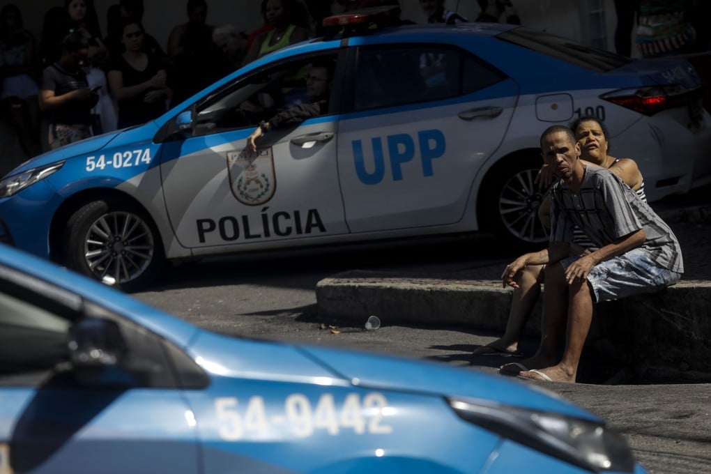 A couple waits outside the Getulio Vargas Hospital for victims of a police raid that killed at least nine people in Rio de Janeiro. Photo: AP