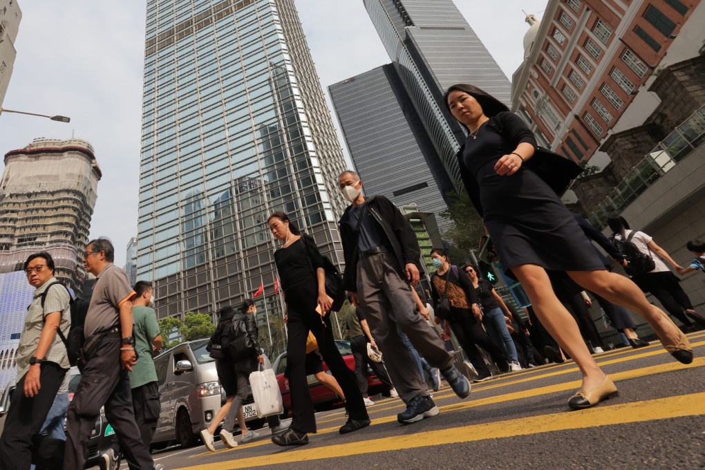 People cross the road in Central, Hong Kong. Employers keen to have workers back in the office are attempting to counter perceived negative impacts of remote working. Photo: SCMP