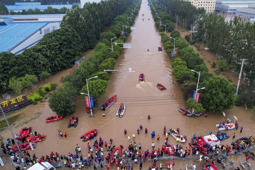 Rescue workers navigate a flooded road at an industrial development zone in Zhuozhou, Hebei province, on Wednesday. Photo: cnsphoto via Reuters