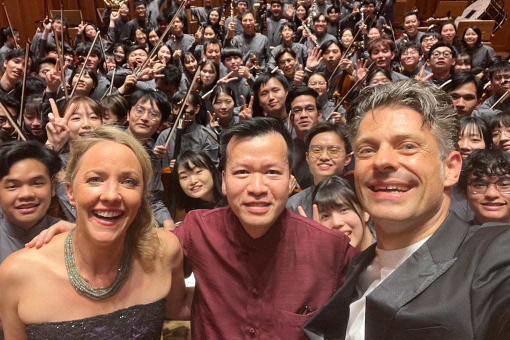 Asian Youth Orchestra general manager Keith Lau (centre) with soprano Lydia Teuscher (left) and AYO principal conductor Joseph Bastian and the orchestra at the Mahler Festival in Dobbiaco, Italy, on July 28, 2023. Photo: AYO