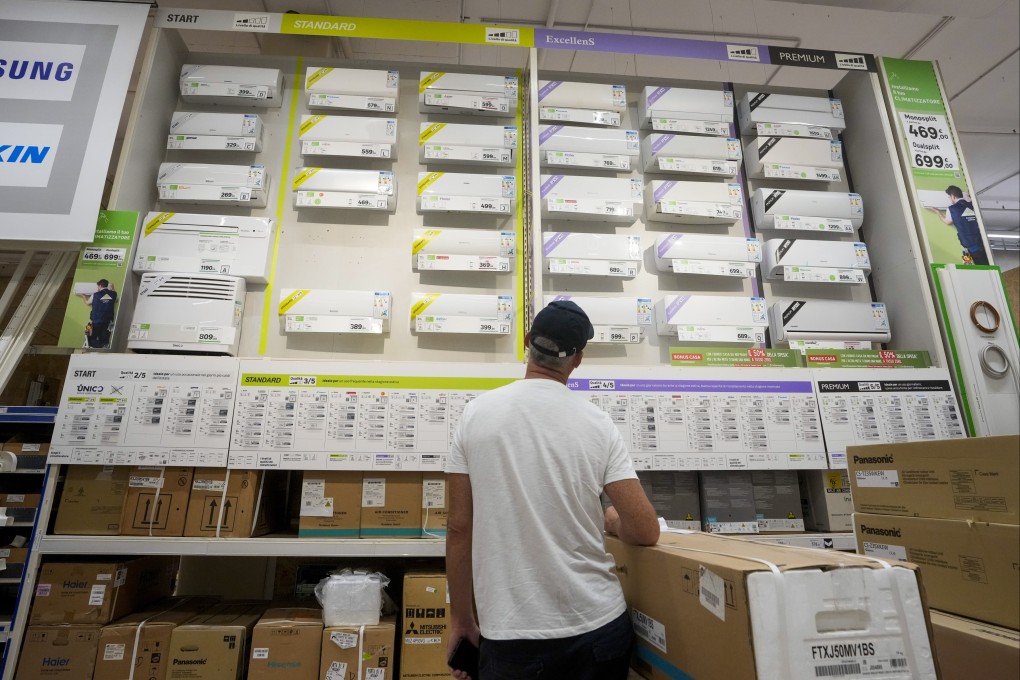 A customer looks at air conditioning units at a Rome department store. As climate change causes summer temperatures to soar in Europe, air conditioner use is rising. Photo: AP