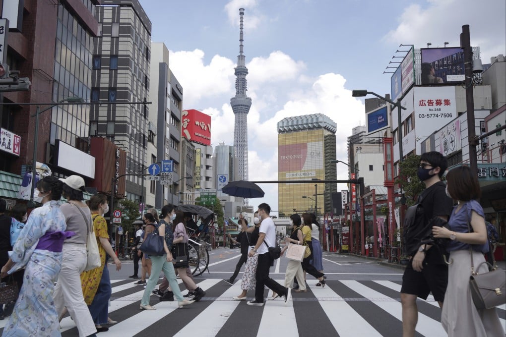 People walk across a pedestrian crossing in Asakusa, Tokyo. Photo: AP