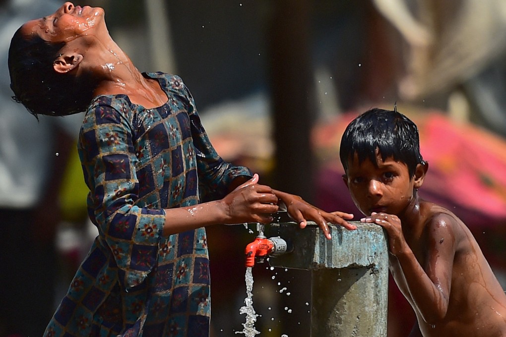 Children in Allahabad, India, cool off at a communal tap during a heatwave last year. Some 76 per cent of children in South Asia are already being exposed to extreme heat, according to the UN. Photo: AFP