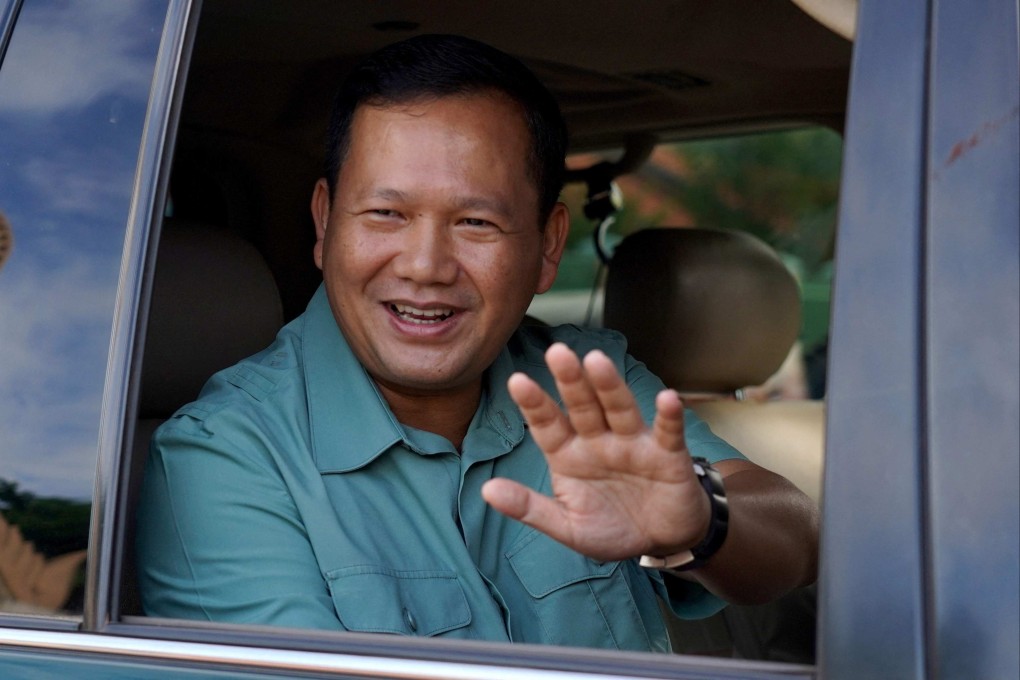 Hun Manet, Hun Sen’s eldest son, waves to onlookers after casting his vote at a polling station in Phnom Penh on July 23. Photo: AFP