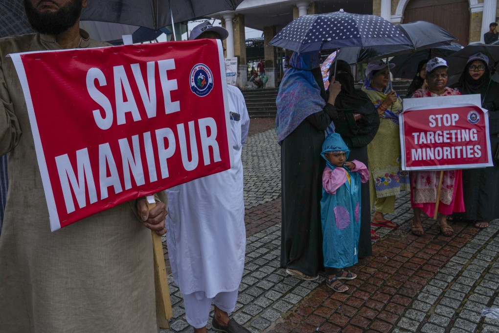 Activists protesting against ethnic violence in India’s northeastern Manipur state hold placards in Mumbai last month. Photo: AP