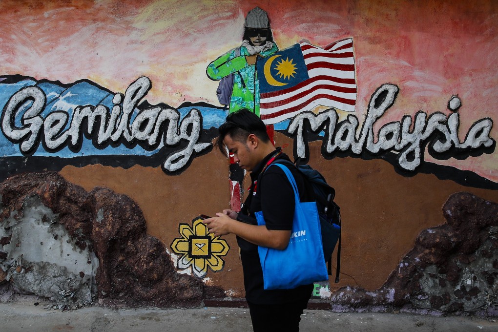 A man stands outside a nomination centre in Gombak, Selangor, last month on state election nomination day. Some 9.7 million Malaysian voters will cast their ballots in 245 constituencies in Saturday’s state polls. Photo: EPA-EFE