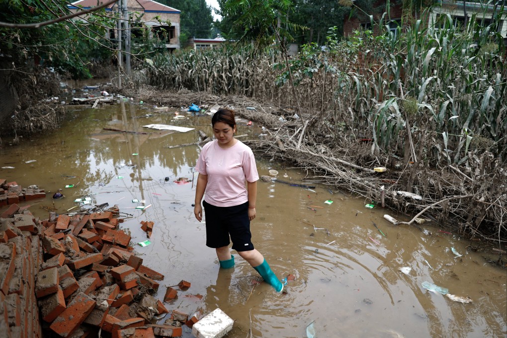 A woman stands in floodwaters near a damaged corn farm in China’s Hebei province on Monday after Typhoon Doksuri hit. Photo: Reuters