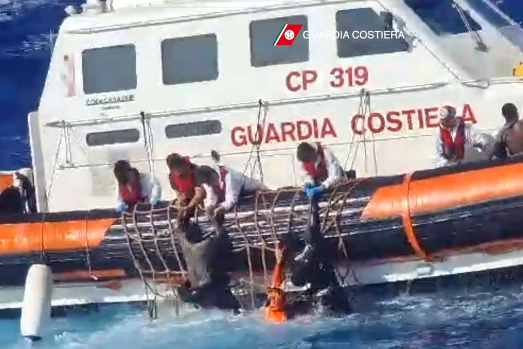 Rescuers help migrants to board a rescue boat during operations that took place south of Lampedusa. Photo: Italian coastguard/AFP