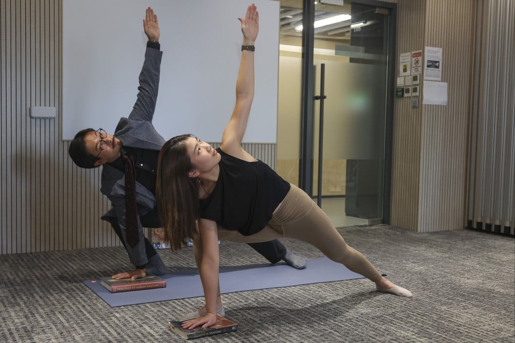 Dr Christopher See (left), a Hong Kong lecturer on anatomy, uses yoga to keep his students engaged and retain knowledge. Research assistant Charlotte Lin (right) strikes yoga poses to illustrate See’s lessons. Photo: Edmond So