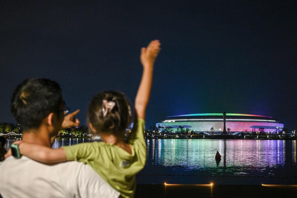 A child waves to the stadium during the closing ceremony of the 31st Fisu Summer World University Games in Chengdu, Sichuan Province, on Tuesday. Photo: Xinhua