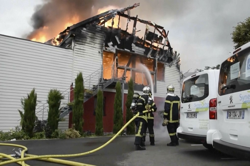 Firefighters try to contain the blaze at a holiday home in north-eastern France on Wednesday. Photo: AP