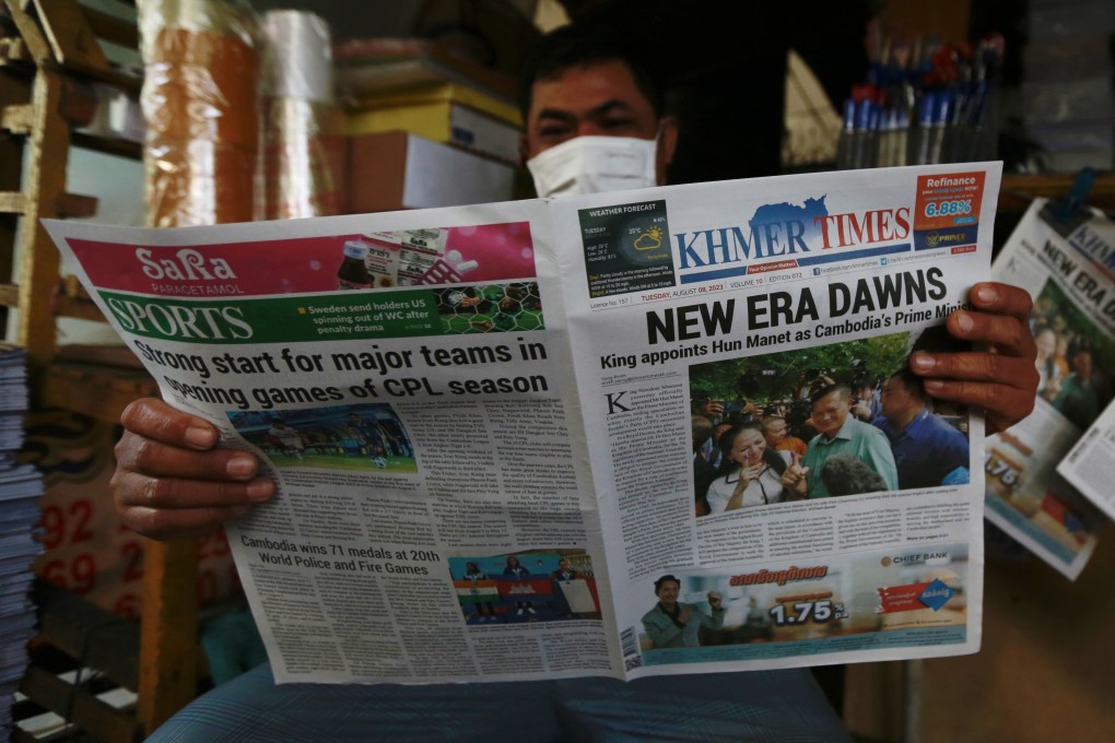 A man reads newspaper at a street in Phnom Penh on Tuesday. Cambodia’s king on Monday appointed army chief Hun Manet, 45, to succeed prime minister Hun Sen, 70. Photo: EPA-EFE